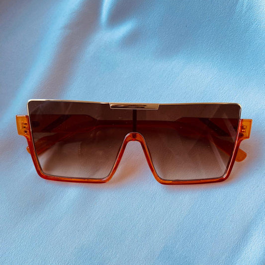 Lentes naranja con detalle dorado